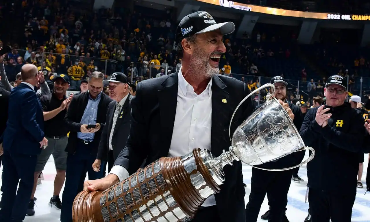 Michael Andlauer holds the Ontario Hockey League (OHL) Memorial Cup on the ice surface after his Hamilton Bulldogs won it in 2022.