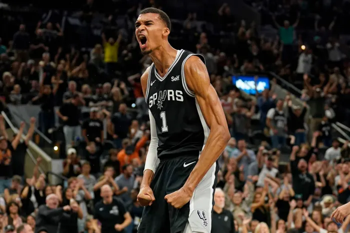 San Antonio Spurs forward Victor Wembanyama (1) reacts after dunking during the second half against the Houston Rockets at Frost Bank Center.