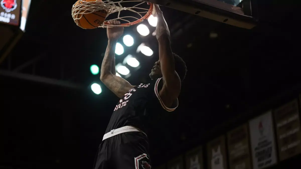 Arkansas State's Izaiyah Nelson rocks the rim with a dunk during the Red Wolves' 85-74 win over the Texas State Bobcats on Saturday.
